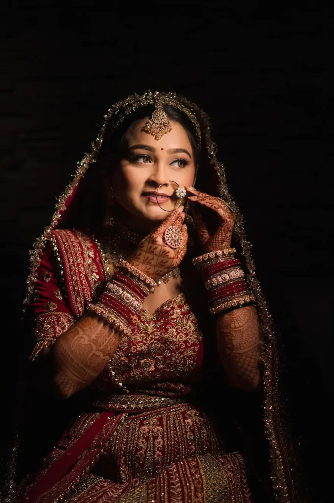 Traditional bridal portrait with elegant jewelry and dark background by the best Wedding Photographer in Dehradun.