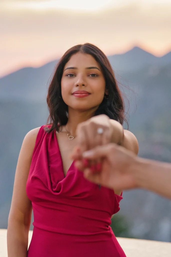 Proposal photography highlighting the engagement ring against a scenic mountain backdrop