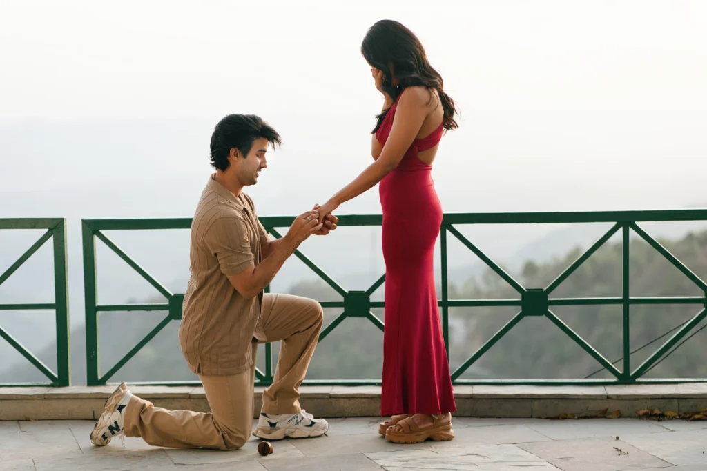 Romantic proposal moment in Mussoorie with a couple overlooking the scenic hills of Uttarakhand