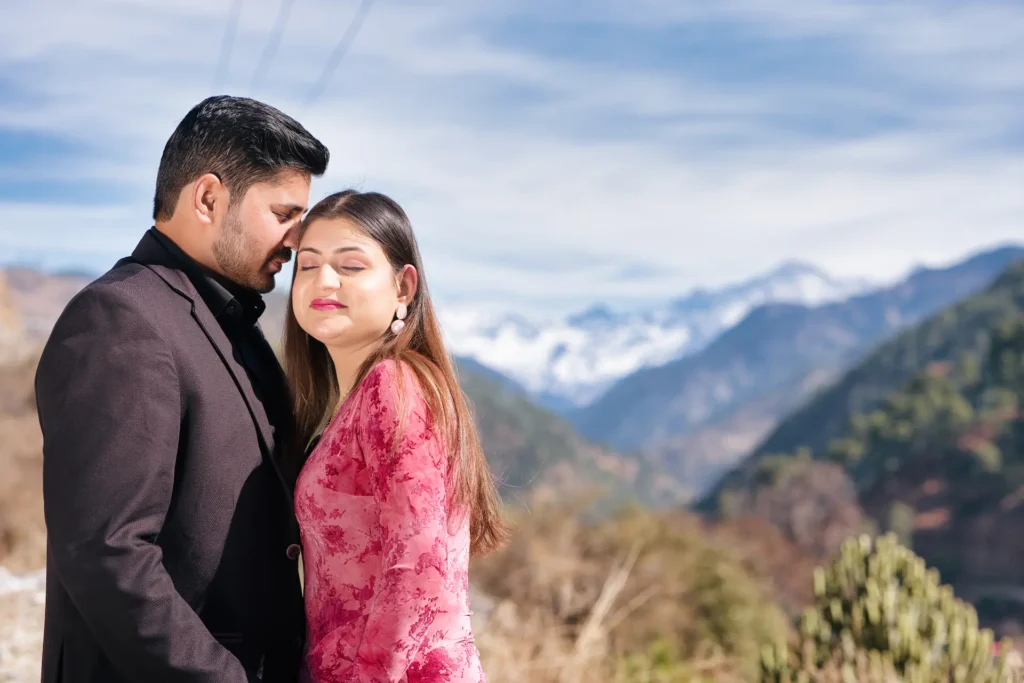 Romantic couple portrait with snow-capped Himalayan mountains creating a breathtaking natural backdrop