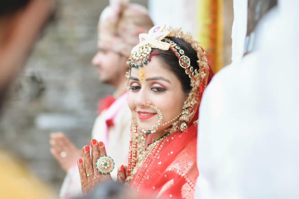 Bride offering prayers during a traditional Triyuginarayan Temple wedding ceremony