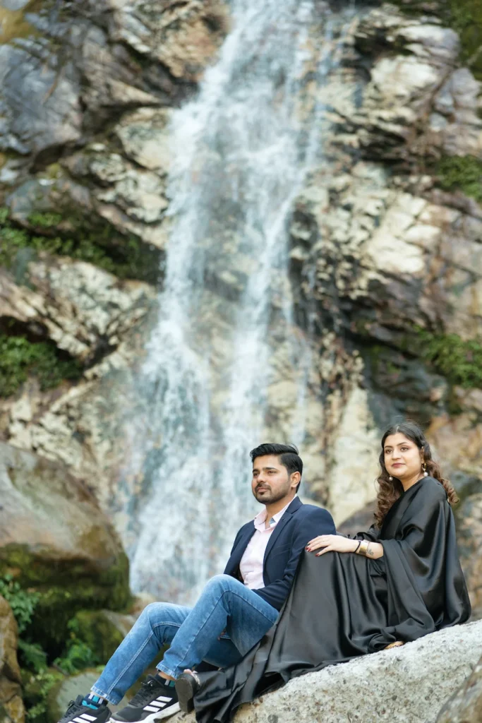 Wedding Photography capturing a romantic couple portrait beside a majestic waterfall surrounded by natural beauty