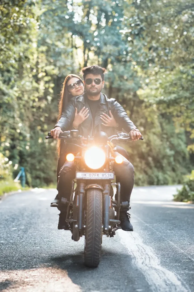 Couple enjoying a motorcycle ride through a peaceful mountain road.