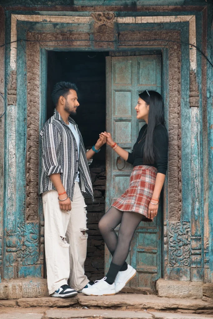 Couple holding hands in front of a traditional heritage doorway