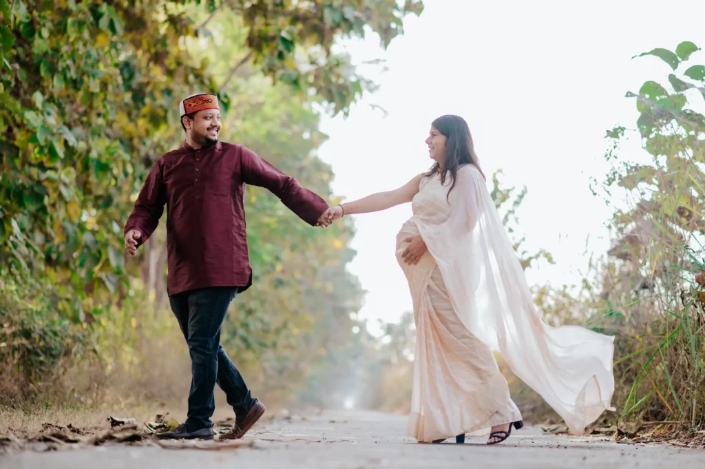 Maternity Shoot in Dehradun featuring an expecting couple holding hands during a romantic outdoor pregnancy photoshoot