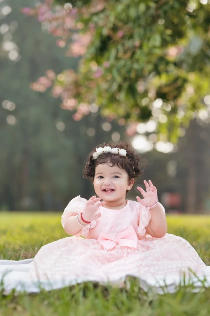 Smiling baby girl enjoying an outdoor Birthday Shoot in Mussoorie