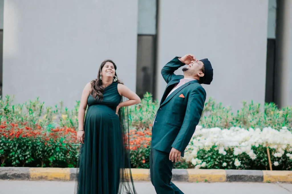 Fun and candid maternity shoot moment with an expecting couple enjoying their pregnancy journey in Dehradun