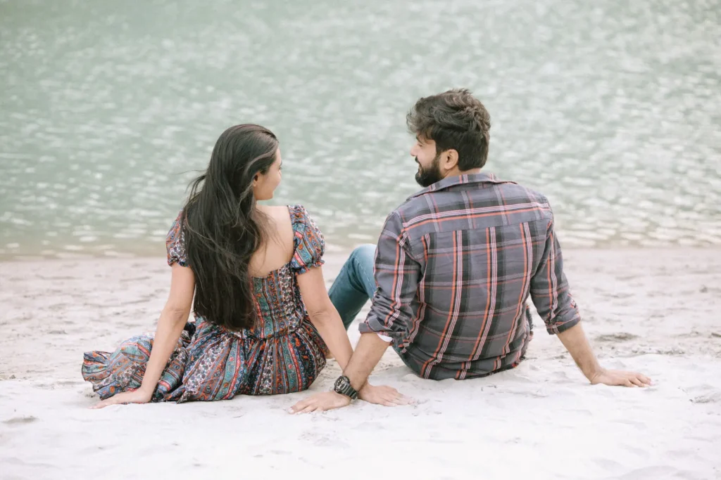 Pre-Wedding Shoot Ideas featuring a couple holding hands by a peaceful lakeside, capturing a romantic and natural outdoor pre-wedding moment