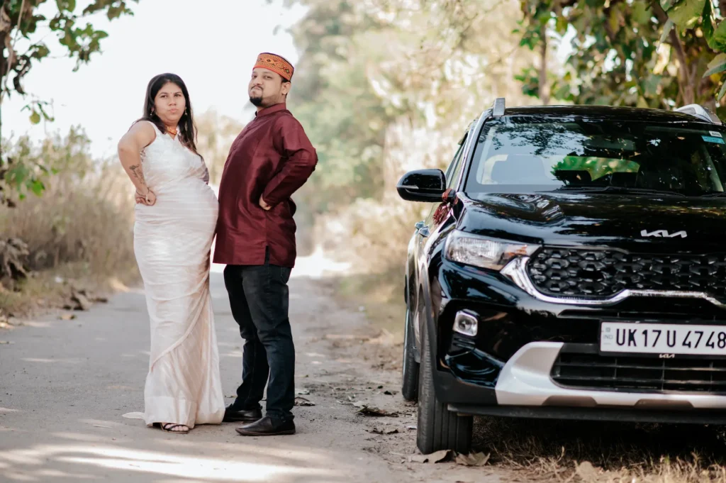 Expecting couple standing beside their car during a natural outdoor parenthood photoshoot