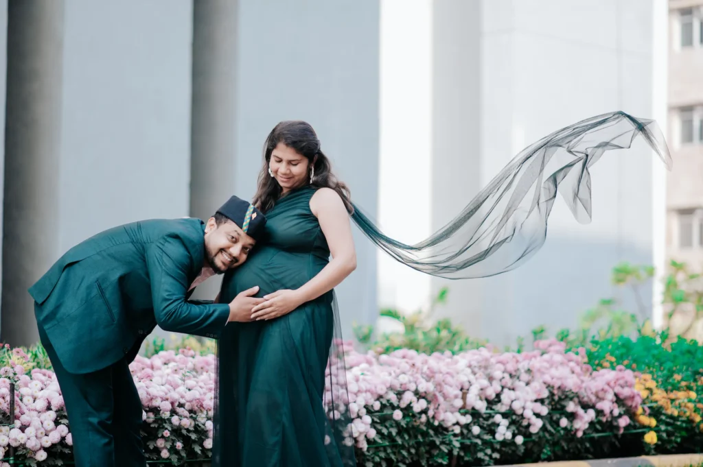 Father-to-be listening to the baby bump while sharing an emotional moment with his partner during a pregnancy portrait session