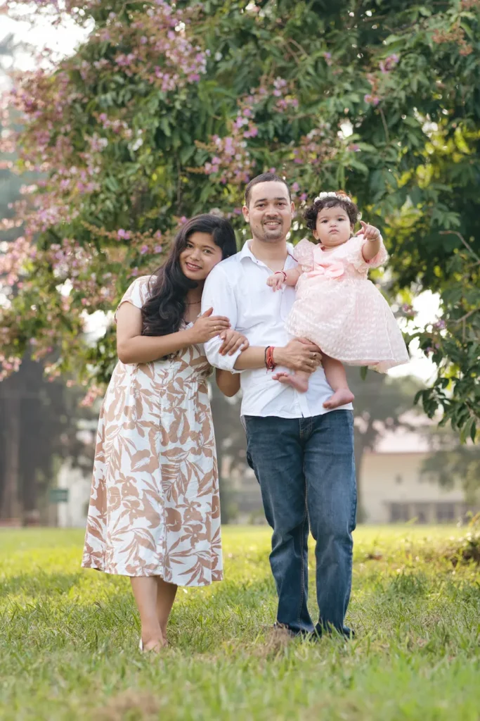 Happy family posing together with their baby during an outdoor portrait session