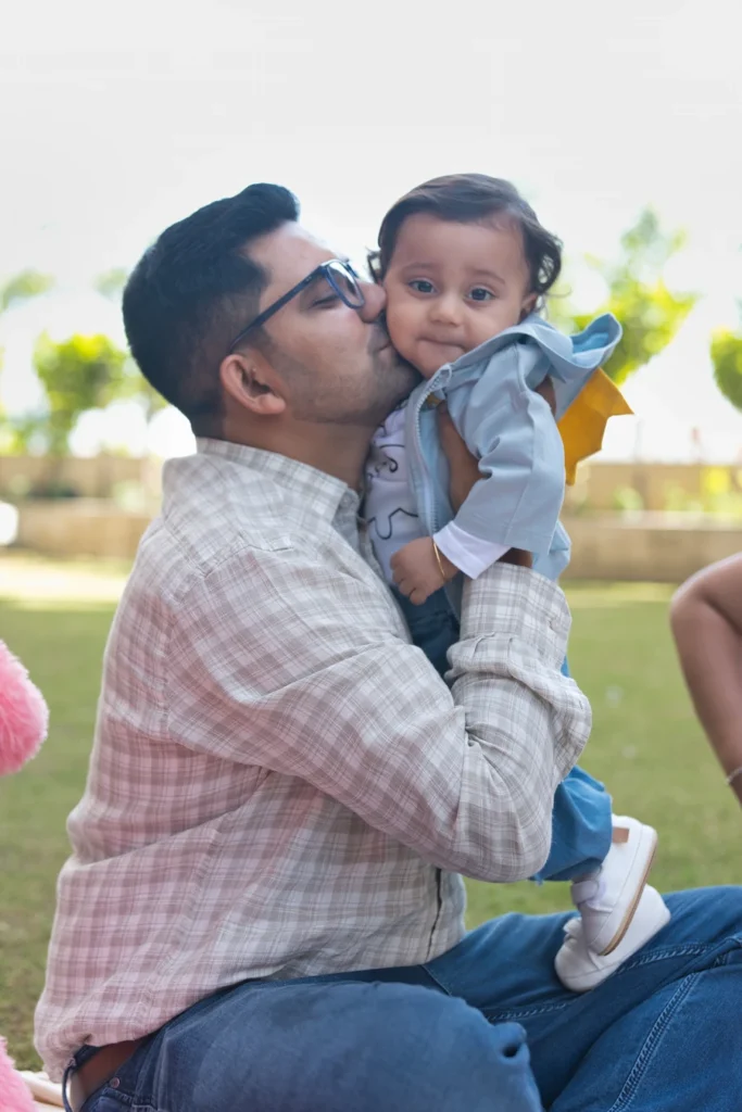 First Birthday father kissing baby Jiyansh during a heartwarming family photoshoot