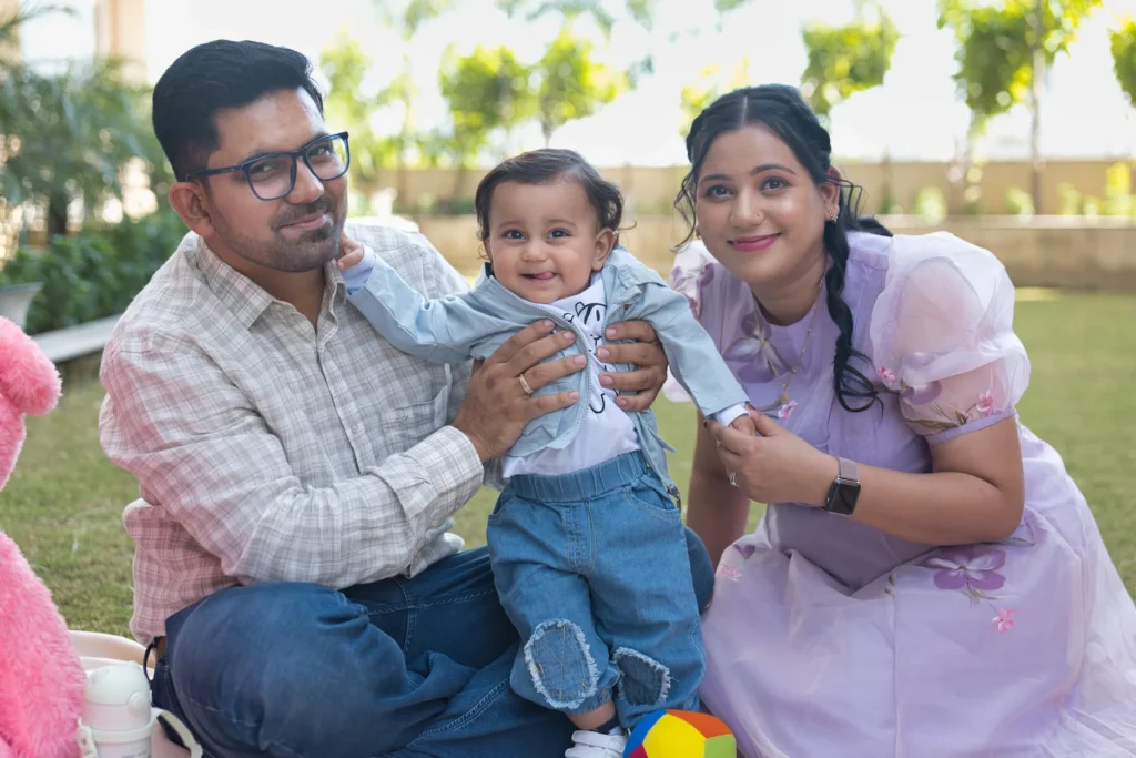 First Birthday family celebration portrait of baby Jiyansh sharing smiles with his parents
