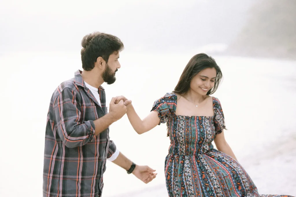 Pre-Wedding Shoot Ideas featuring a couple holding hands by the Ganga River during a romantic outdoor photoshoot
