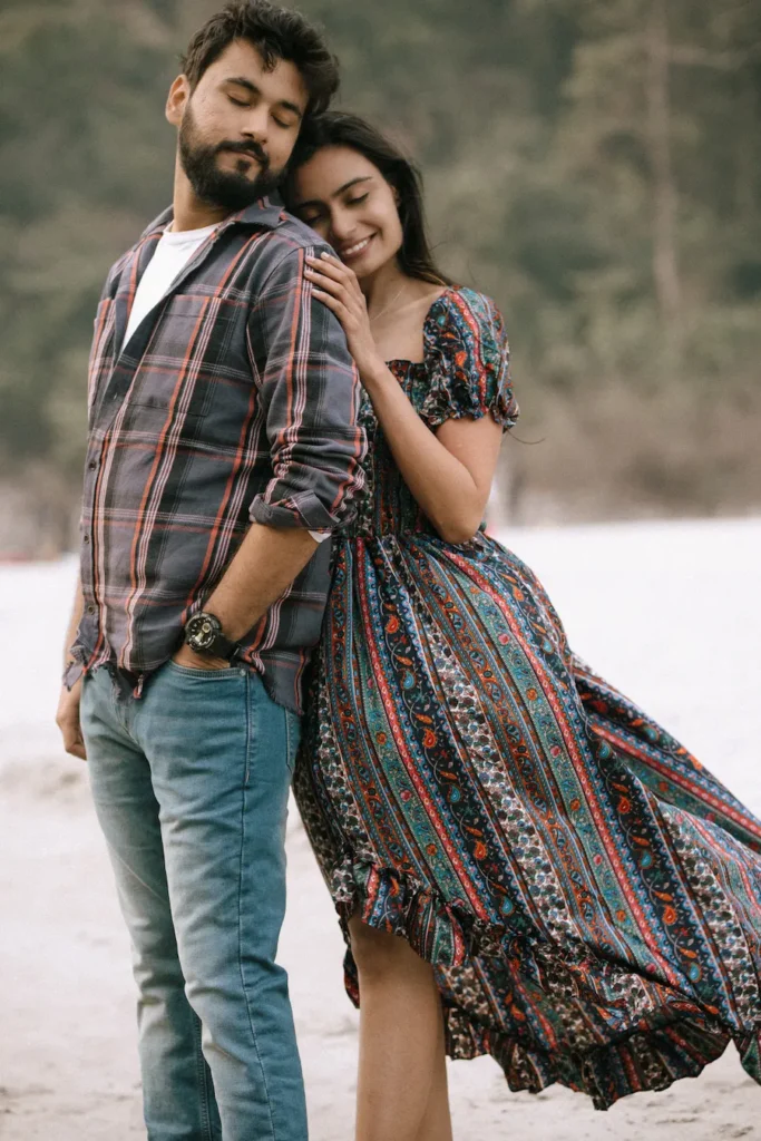 Close-up portrait of a couple sharing a peaceful embrace with soft expressions in a natural outdoor setting