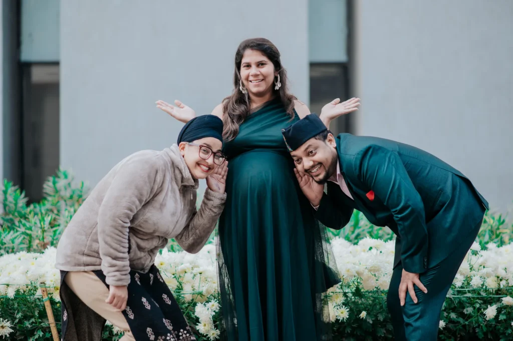 Family members sharing a joyful moment with parents-to-be during a pregnancy celebration photoshoot