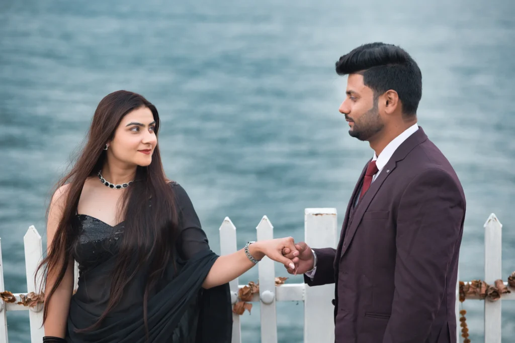 Romantic Tehri Pre Wedding Shoot at Tehri Lake featuring a couple enjoying a scenic boat photoshoot amidst the beautiful mountains of Uttarakhand.