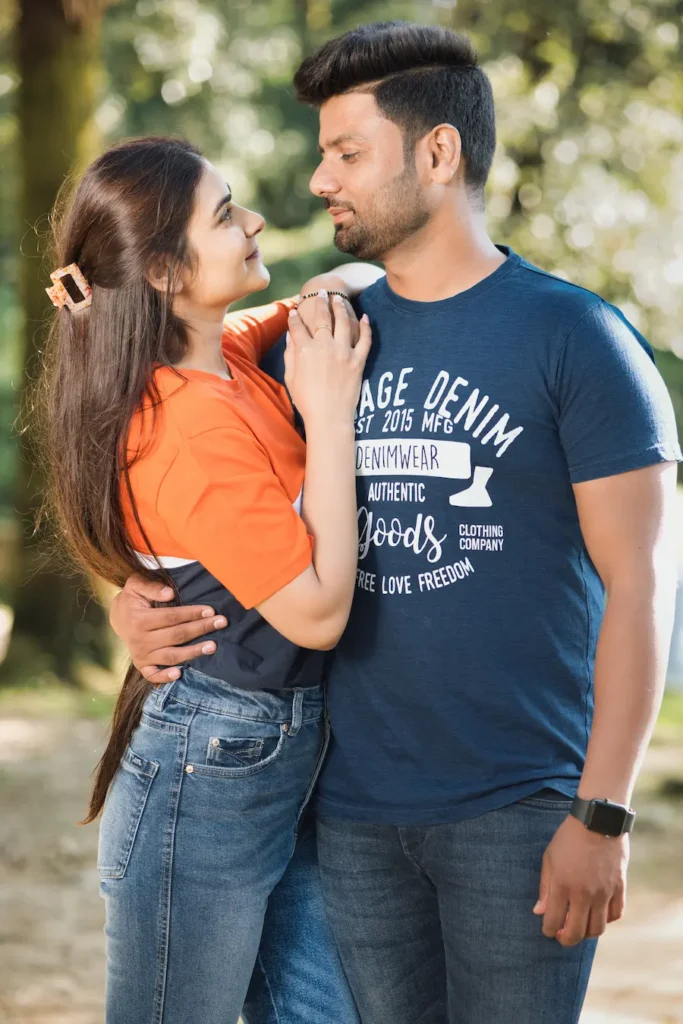 Candid portrait of a couple looking into each other’s eyes outdoors.