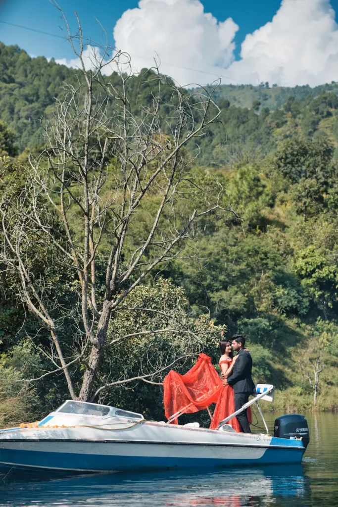 Couple posing on a speedboat surrounded by calm lake waters.
