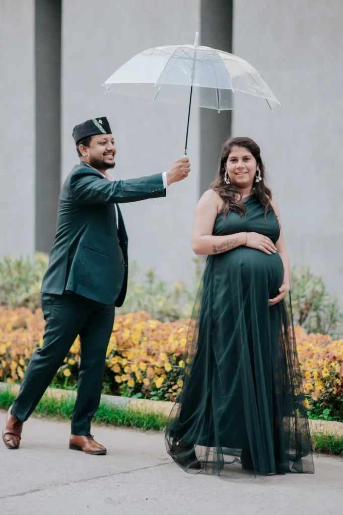 Father-to-be holding a transparent umbrella while sharing a joyful moment with his partner outdoors