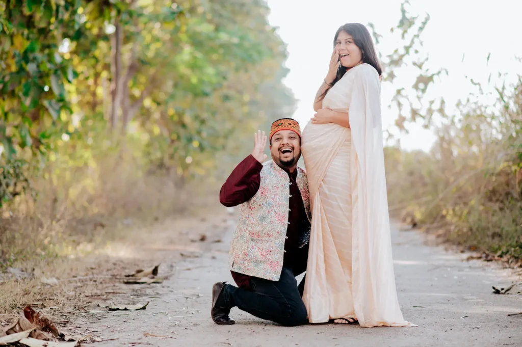 Maternity Shoot in Dehradun featuring an expecting couple sharing a joyful outdoor moment surrounded by natural light