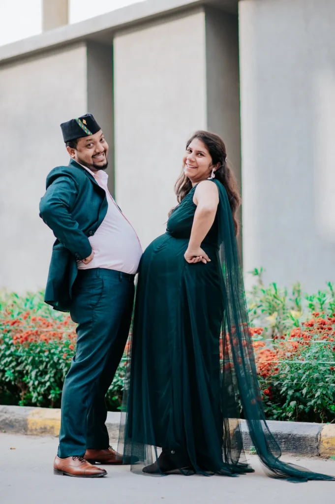 Happy parents-to-be posing together in elegant outfits while celebrating their journey to parenthood