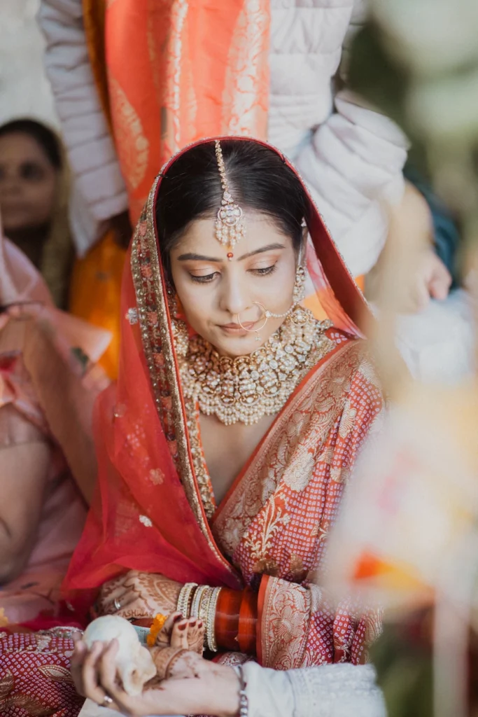 Candid close-up of a bride in traditional attire during wedding rituals with natural emotional expression