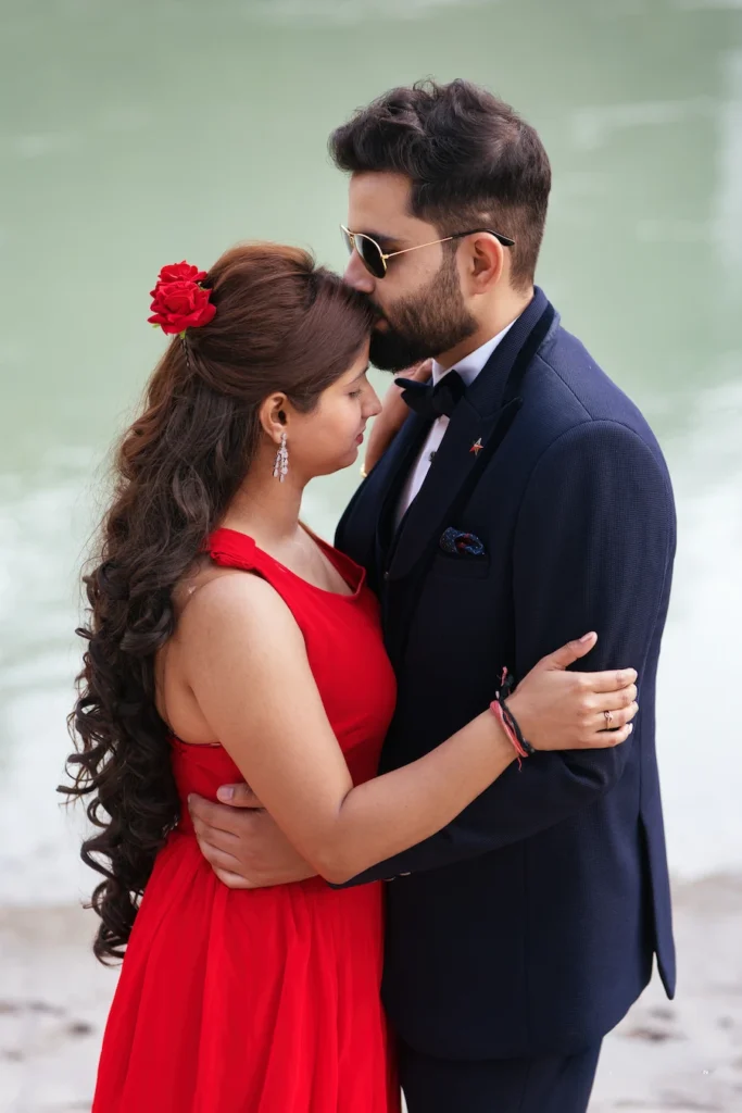 Romantic couple embracing by the riverside during a natural outdoor pre-wedding photoshoot