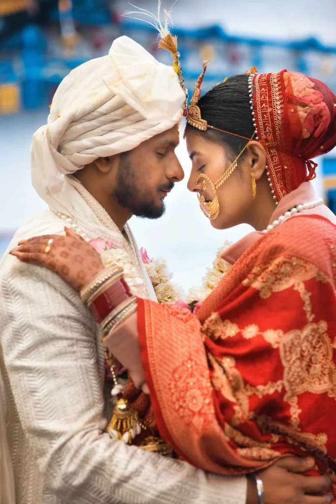 Bride and groom sharing an intimate moment in traditional wedding attire