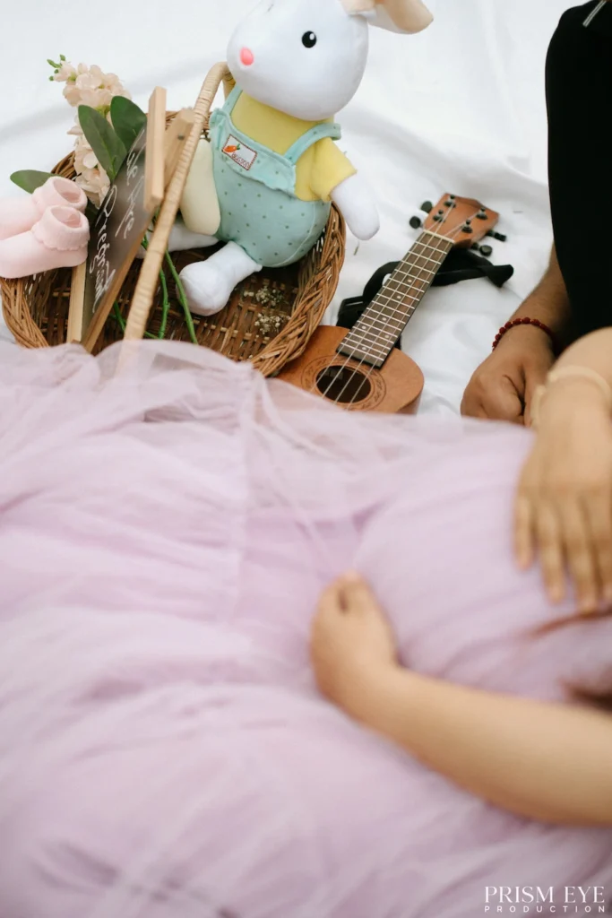 Baby-themed basket featuring a stuffed rabbit, flowers, and keepsake props prepared for a maternity session.