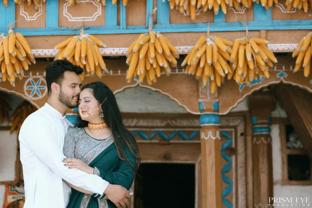 Pre-Wedding Shoot couple embracing in a traditional corn village with rustic architecture