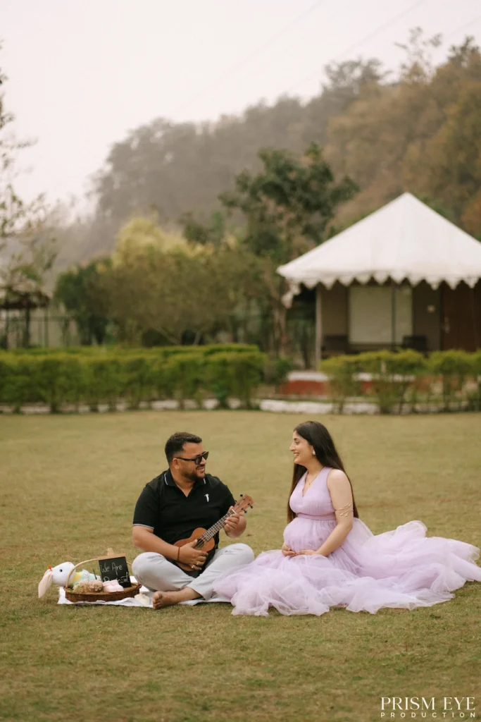 Expecting couple enjoying a relaxed outdoor moment while celebrating their journey to parenthood.