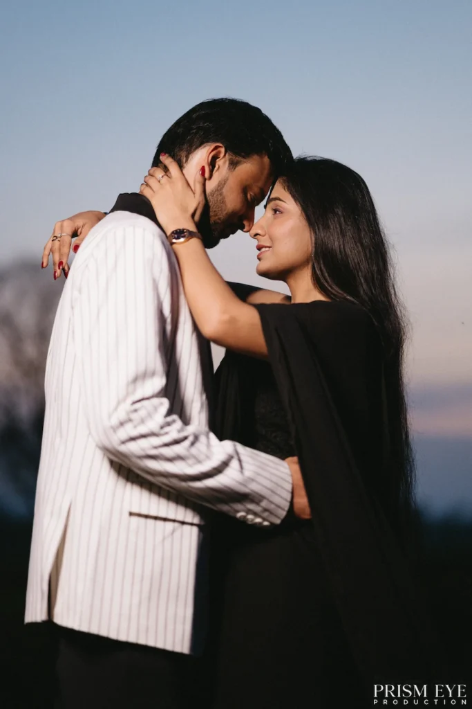 Couple embracing during a romantic sunset pre-wedding photoshoot outdoors.