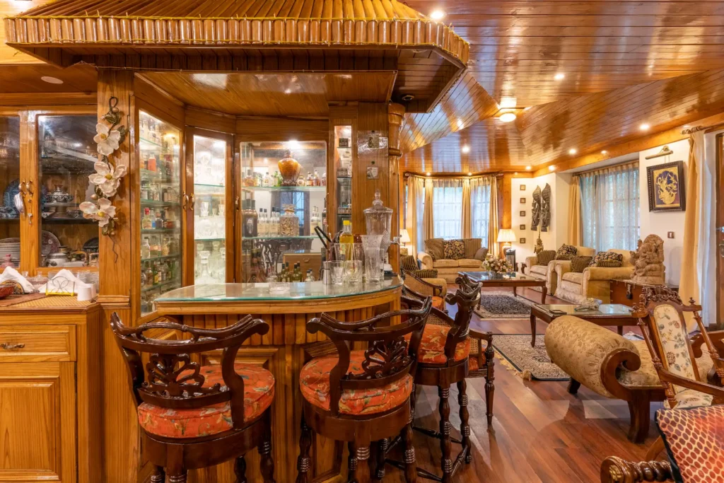 Luxury home bar and lounge area with handcrafted wooden interiors and elegant furniture.