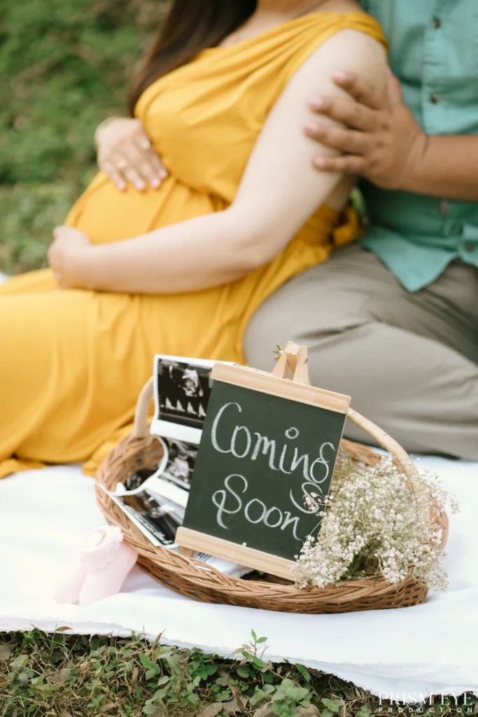 Close-up of caring hands gently embracing a growing baby bump during a maternity portrait.
