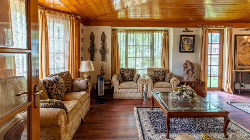 Classic living room with wooden ceiling, large windows, comfortable seating, and sophisticated interior décor.