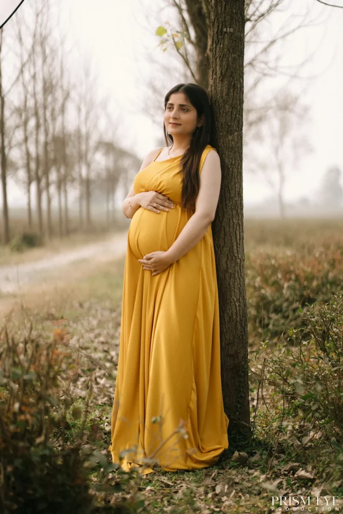 Baby announcement details featuring tiny shoes, themed props, and a coming soon basket arranged for a pregnancy photoshoot.