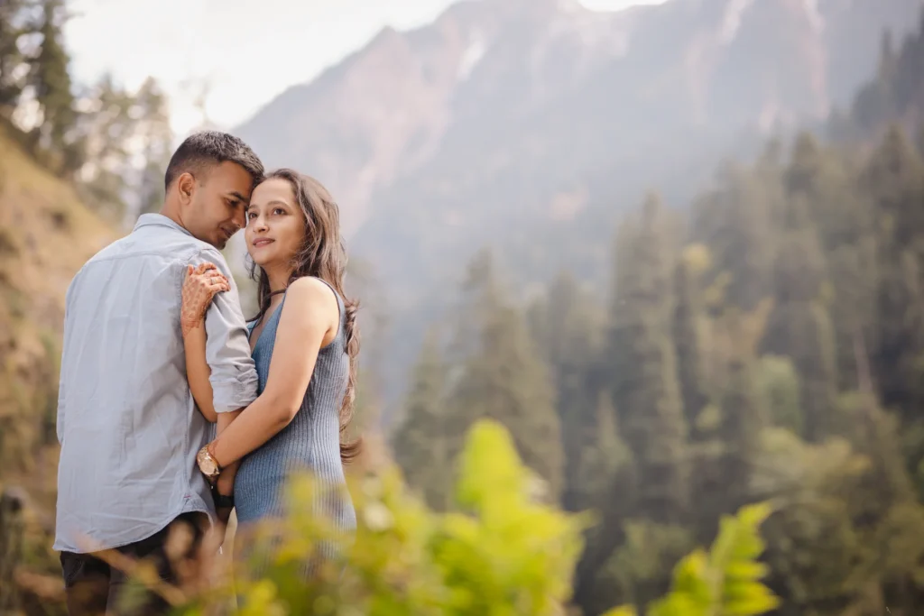 Couple enjoying a romantic Pre-Wedding Shoot in Harshil surrounded by scenic Himalayan mountains and pine forests.
