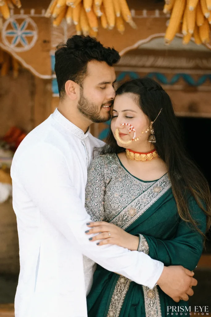 Couple sharing a warm hug in a rustic village courtyard with traditional wooden architecture