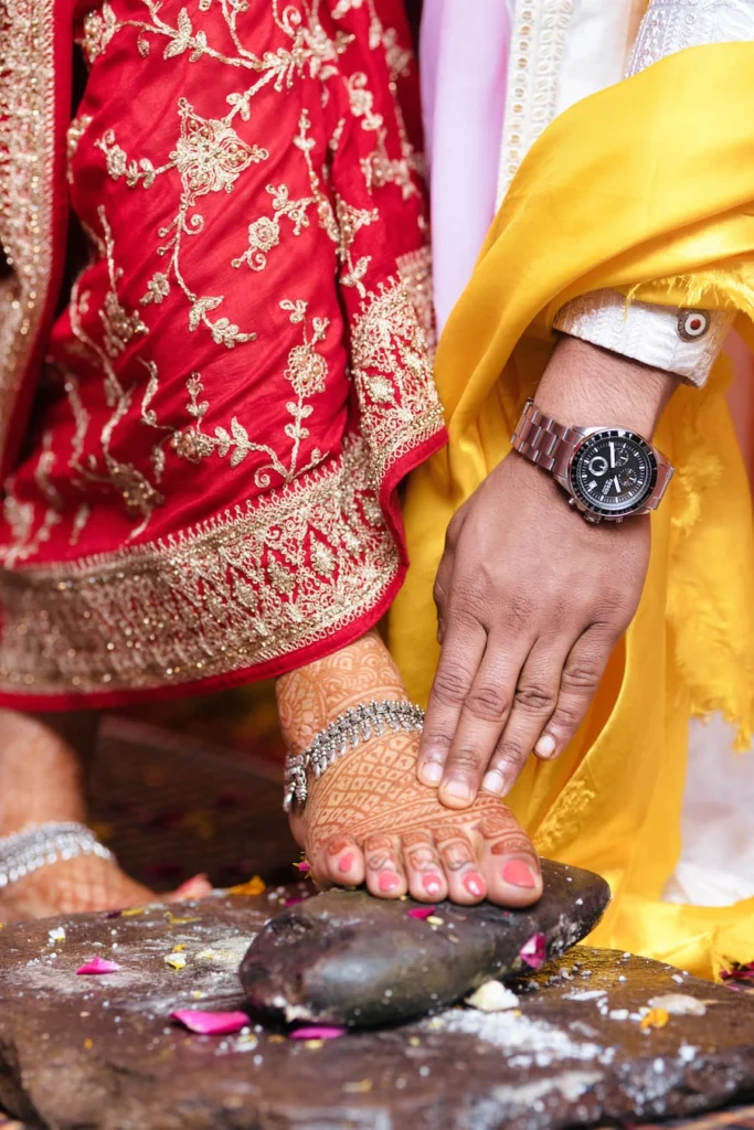 Bride and groom performing a sacred wedding ritual during a traditional Hindu wedding ceremony