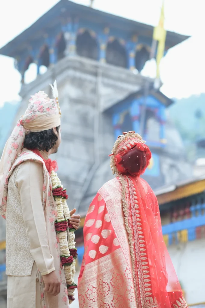 Bride and groom standing outside a historic temple before their wedding ceremony.