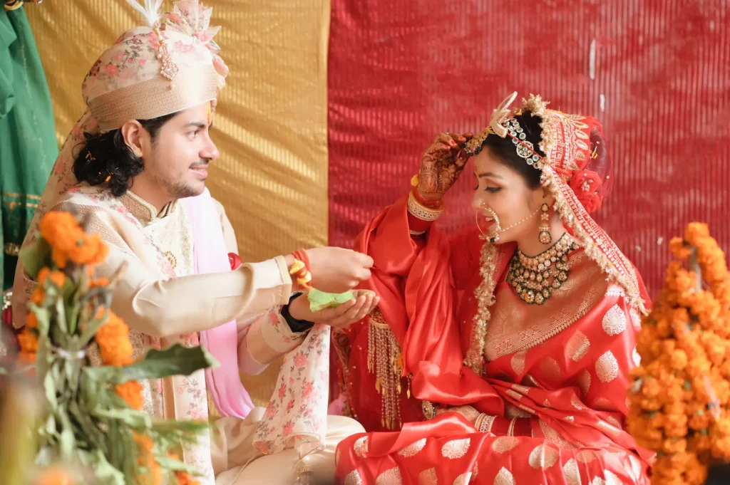 Bride and groom performing a sacred wedding ritual during their traditional marriage ceremony.