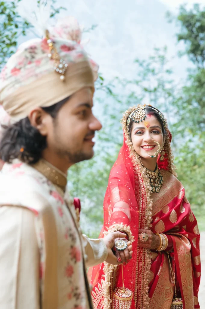 Bride smiling at the groom during a Triyuginarayan Wedding, capturing authentic emotions and traditional Garhwali wedding rituals.