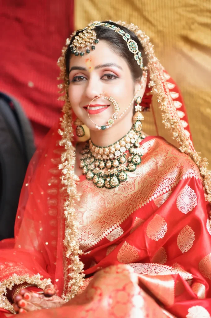 Elegant bridal portrait showcasing traditional jewelry, silk saree, and radiant wedding smile.
