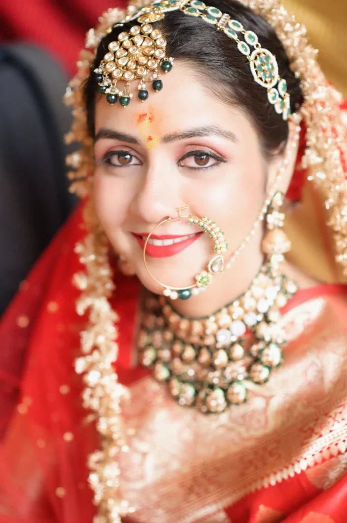 Close-up bridal portrait highlighting intricate jewelry, bridal makeup, and graceful expressions.