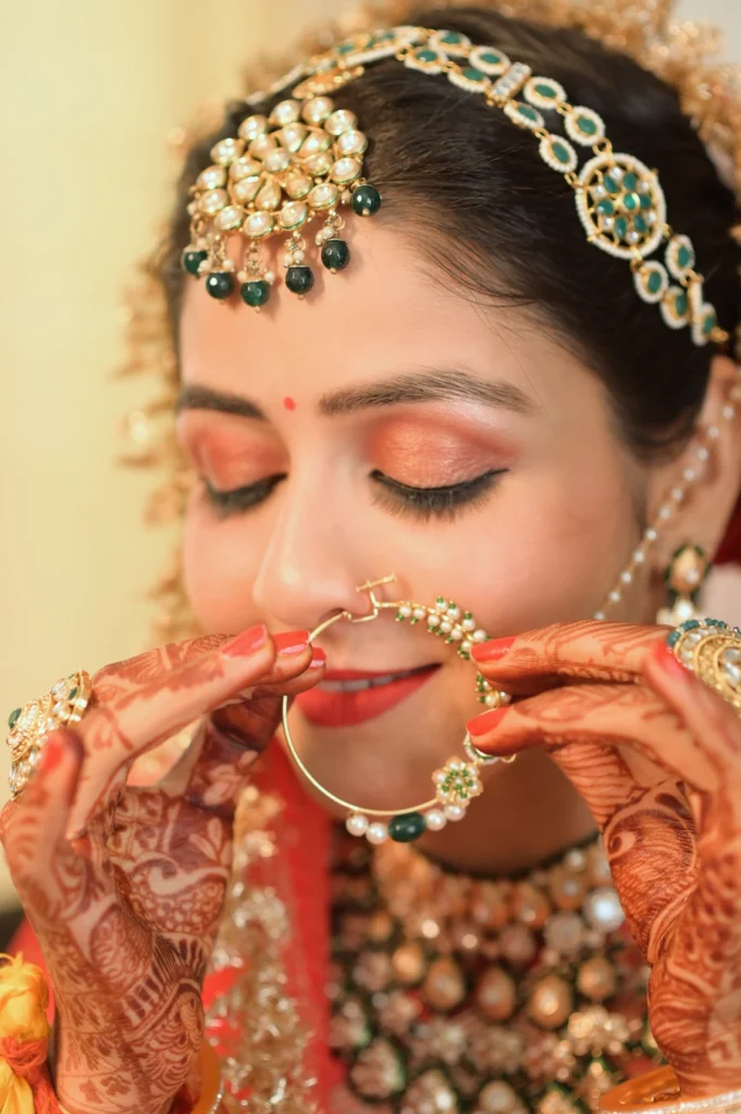 A beautiful close-up of a bride wearing intricate traditional jewelry and mehendi during her wedding in Uttarakhand.