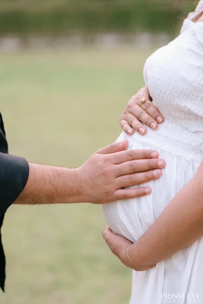Loving hands gently resting on a pregnant belly, celebrating the journey into parenthood.