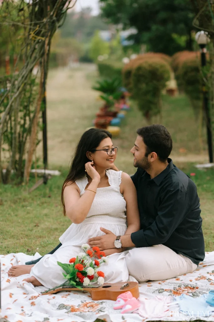 Expecting parents sharing laughter beneath a rustic garden arch during an outdoor pregnancy session.