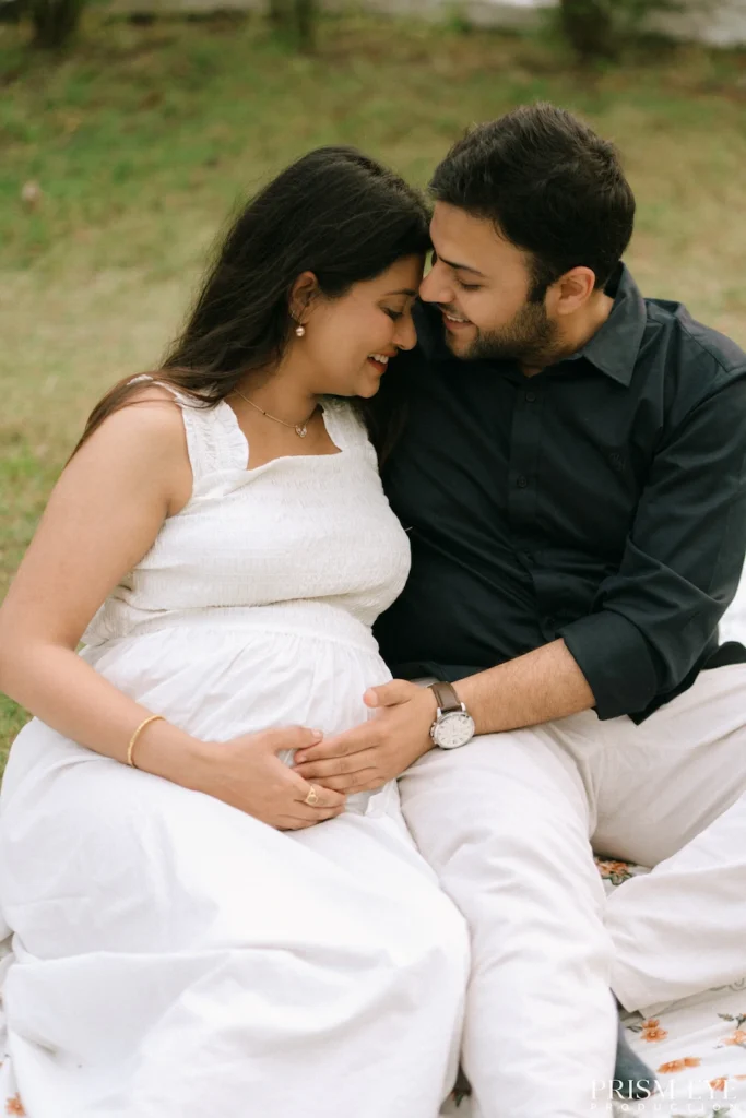 Expecting couple sitting together and sharing a quiet, emotional moment before welcoming their baby.