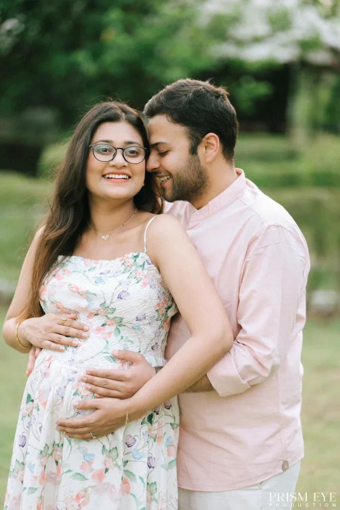 Happy parents-to-be embracing and smiling while celebrating the final weeks of pregnancy.